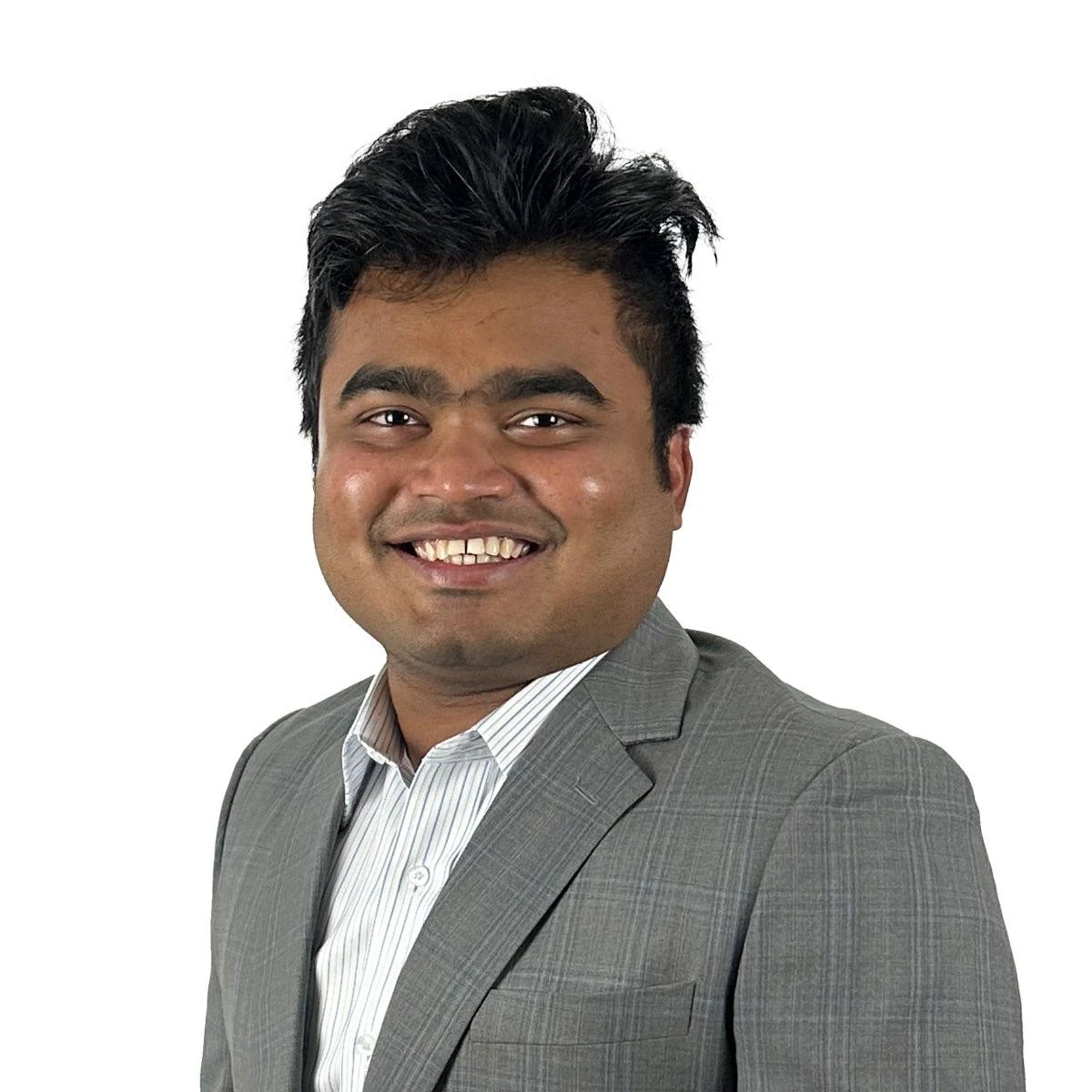 Aadib wearing a gray suit jacket and smiling